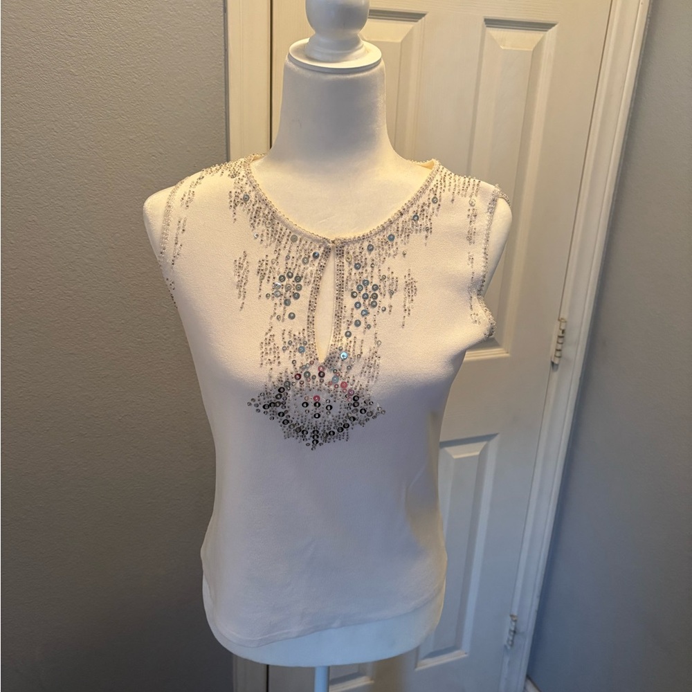 White top with sequin details around the neckline. Size large. Stretch material